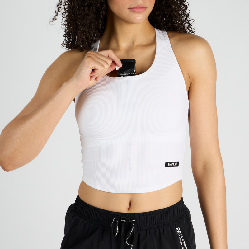 Cadence™ Performance Tank with concealed pockets and mesh internal shelf bra, designed for moisture management and comfort.