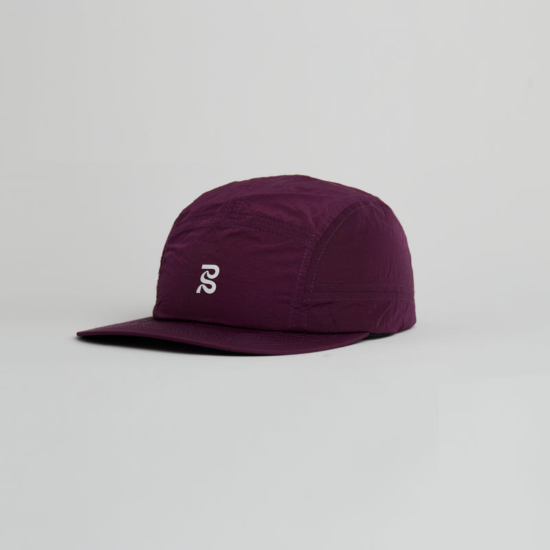 Current Run Hat in Raisin color with breathable mesh panels and adjustable fit.