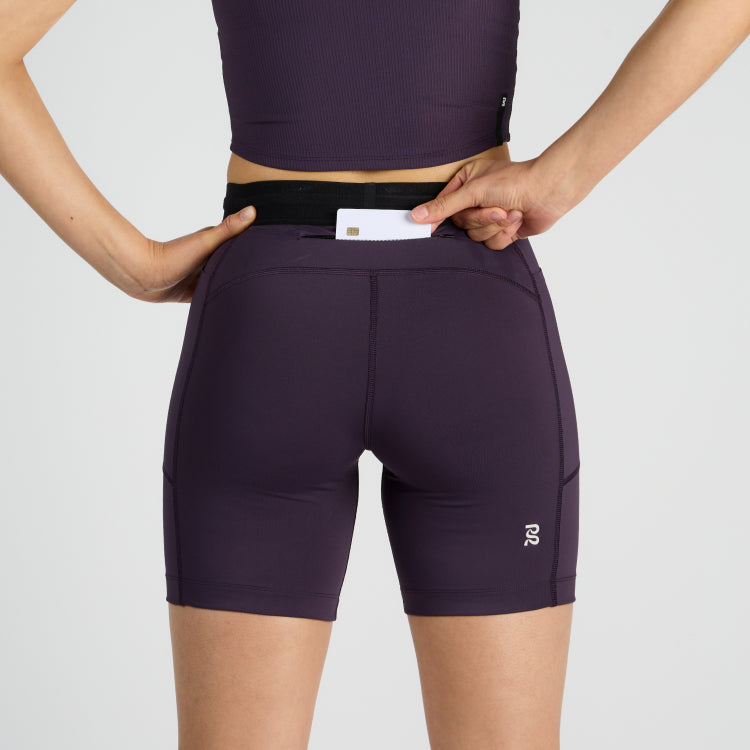Stamina™ 7" Women's Compression Shorts in Nightshade with anti-bounce pockets and reflective logos.